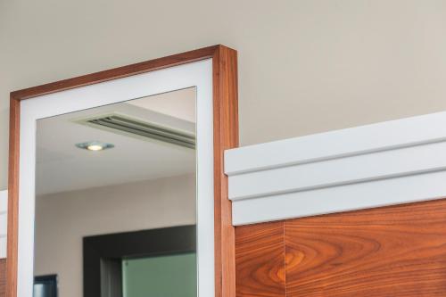 a wooden door with a mirror in a room at Bareti Boutique Estate in Kallithea Halkidikis