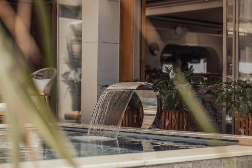 a water fountain in front of a building at Sun Hotel By En Vie Beach in Alanya