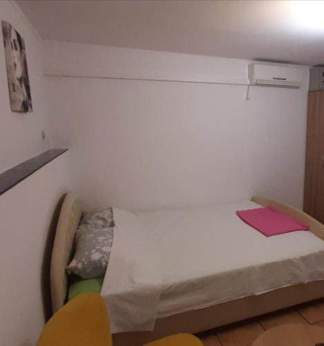 a small room with a bed and two chairs at Grika apartment in Split