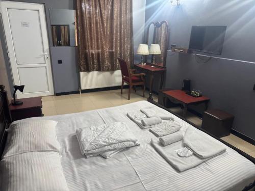 Un dormitorio con una cama con toallas. en Hotel In Georgia, en Zestafoni