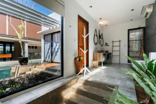 a pivot door in a house with a pool at La Villa Langkawi - Private Pool in Pantai Cenang