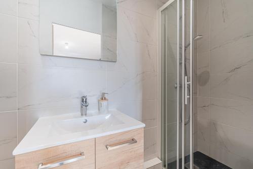 a white bathroom with a sink and a shower at Chill & Work - Welc'Home in Limoges