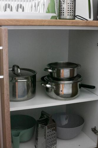 two pots and pans on a shelf in a kitchen at Autocamp Slunce Žandov in Žandov
