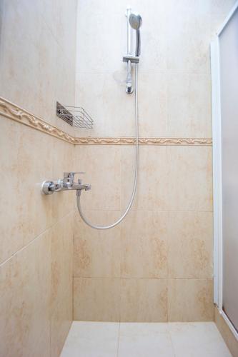a shower with a shower head in a bathroom at Apartments Natasa in Sveti Stefan