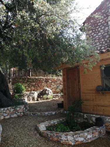 a building with a door and a stone wall at Restored stone house with terrace and gardens in Demre