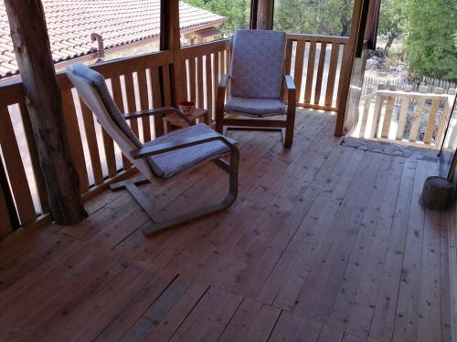 a rocking chair and a chair on a porch at Restored stone house with terrace and gardens in Demre
