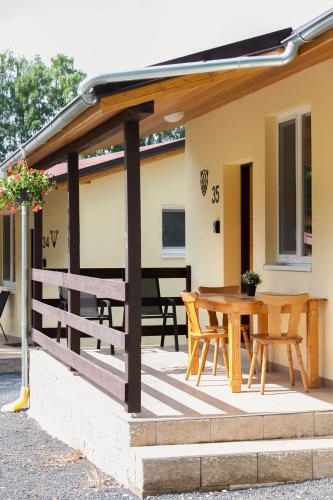 a patio with awning and a table and chairs at Autocamp Slunce Žandov in Žandov