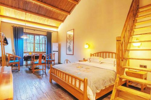 a bedroom with a bed and a dining room at Dayong Antique Feature Resort in Zhangjiajie