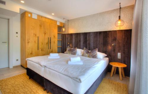 a bedroom with a large bed with a wooden wall at Beautiful Apartment In Rogasovci in Rogašovci