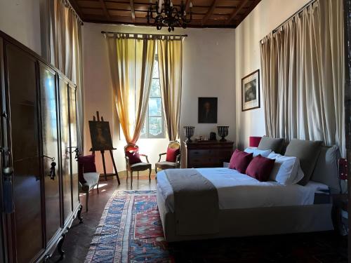 a bedroom with a large bed and a window at Villa Gnecchi Lake Como in Garlate