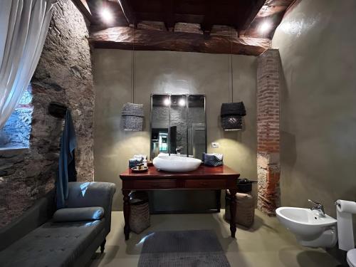 a bathroom with a sink and a mirror and a tub at Villa Gnecchi Lake Como in Garlate