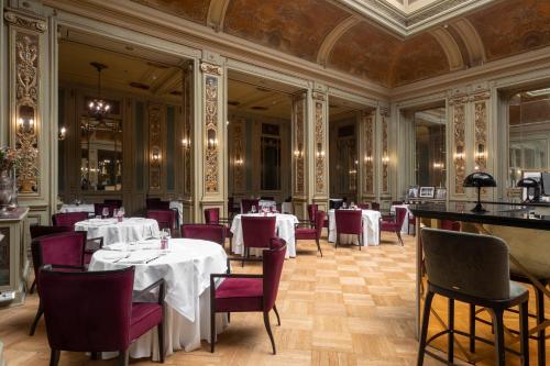 a dining room with white tables and purple chairs at Grand Hotel Et Des Palmes in Palermo