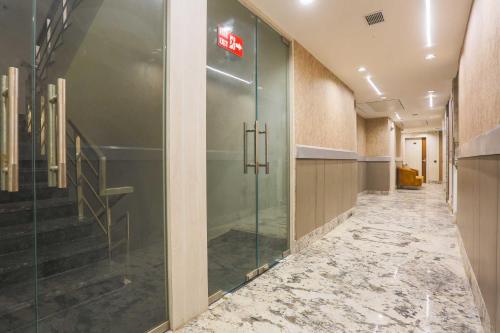 a hallway with a glass door in a building at Townhouse Hisar in Hisār