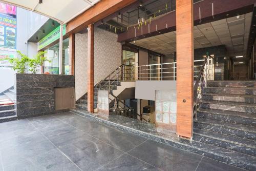 a lobby of a building with stairs in front at Townhouse Hisar in Hisār