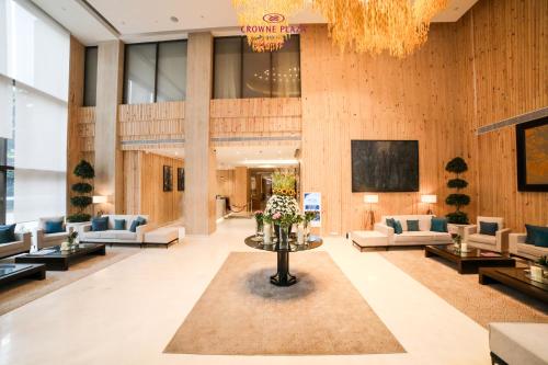 a lobby with couches and a table with flowers at Crowne Plaza Pune City Centre by IHG in Pune