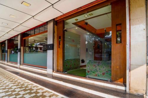 a store front with glass windows on a street at Hotel O City Center Ernakulam in Cochin