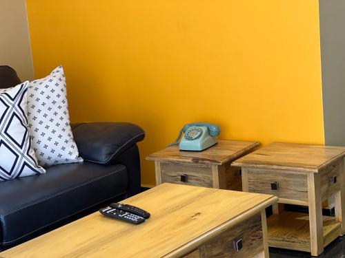 a living room with a couch and two tables at The Oasis in Buwate
