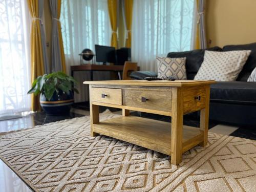 a living room with a coffee table and a couch at The Oasis in Buwate