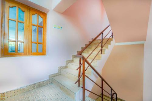 a staircase in a house with a window at Collection O Singanallur Coimbatore in Coimbatore