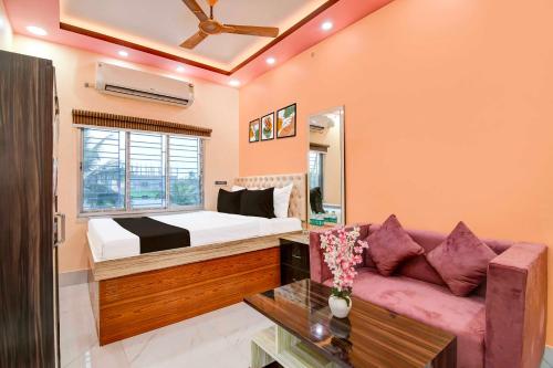 a living room with a bed and a couch at Collection O Kakdwip in Kākdwīp