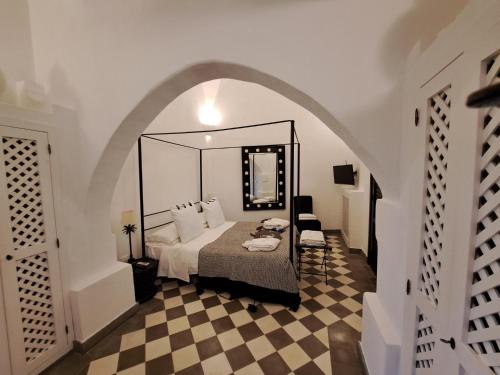 a bedroom with a bed with a large mirror at Il Baglio sull'Acqua in Favignana