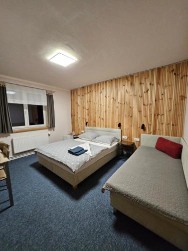 a bedroom with two beds and a window at Hotel Park in Ostružná