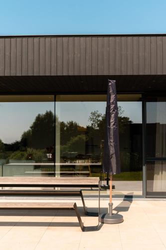 a bench in front of a building with a large window at VAKANTIEDOMEIN DOUVE in Heuvelland