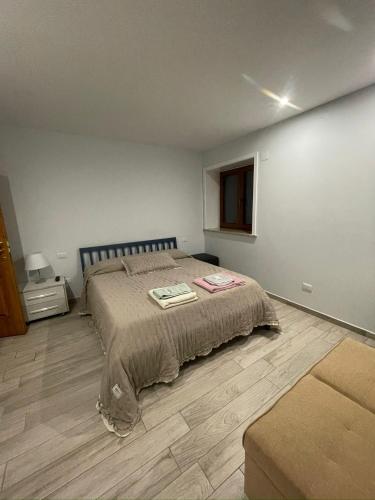 a bedroom with a bed and a wooden floor at VILLA IZZO B&B in Bagnoli