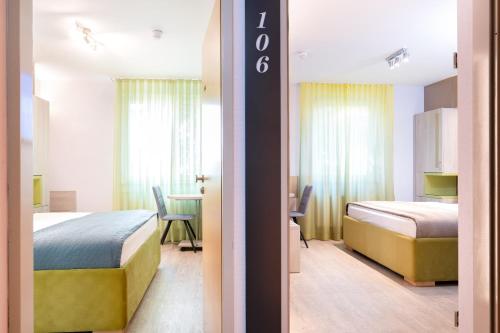 a hotel room with a bed and a dining room at HOTEL Am Spichernplatz in Düsseldorf