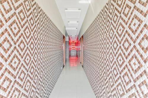 a hallway of a building with a brick wall at Hotel O Sai Kohinoor in Shirdi