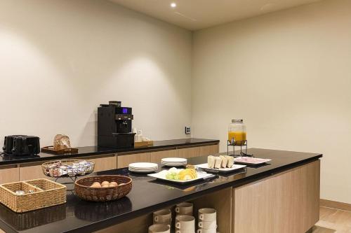 a kitchen with a counter with food on it at The Hound Hotel Changwon Terminal in Changwon