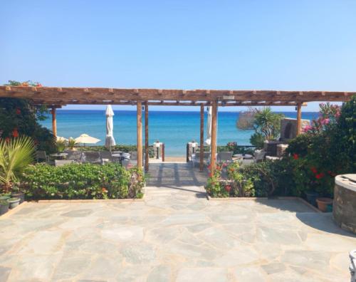 a patio with the ocean in the background at Studios Margarita in Platis Yialos Sifnos
