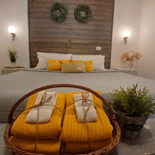 a bedroom with a large bed with yellow blankets and towels at Casa Fiorita 22 Porto Ceresio in Porto Ceresio
