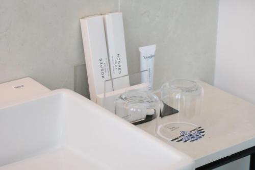 a white counter with two glass bowls and a box at Hospes Palau de La Mar, Valencia, a Member of Design Hotels in Valencia
