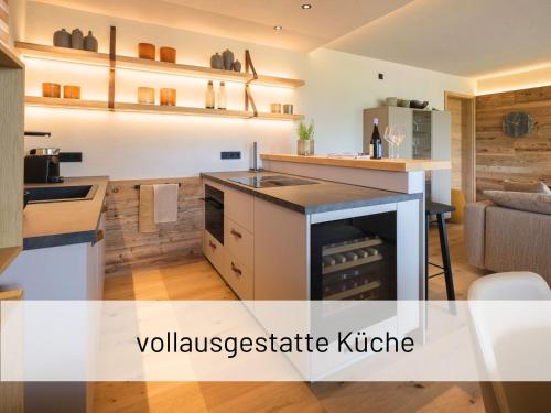 a kitchen with a stove top oven in a room at Hoimat Pfronten - Luxusappartements mit Sauna und Bergblick in Pfronten