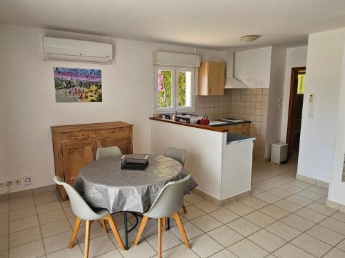 une cuisine et une salle à manger avec une table et des chaises dans l'établissement T2 45 M2 climatisé proche plage, à Eccica-Suarella