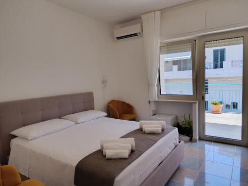 a bedroom with a bed with two pillows on it at La Tartana in Castro di Lecce