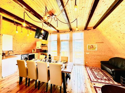 a dining room with a table and chairs at Lake Retreat Colibita in Colibiţa