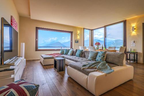 a living room with a couch and large windows at Casa Bella Vista in Laveno
