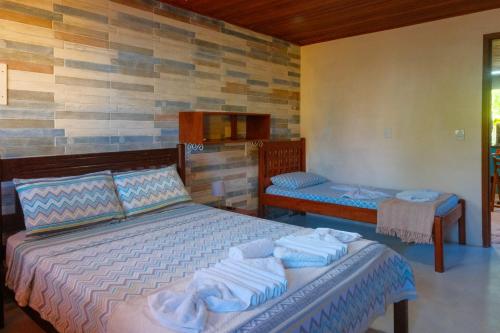 Ένα ή περισσότερα κρεβάτια σε δωμάτιο στο Casa Manhapeba