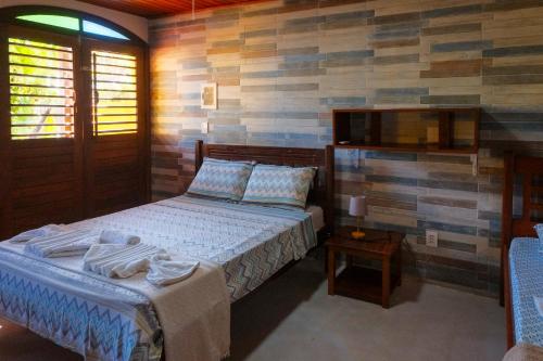 Ένα ή περισσότερα κρεβάτια σε δωμάτιο στο Casa Manhapeba