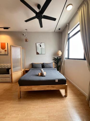 a bedroom with a bed with a ceiling fan at Chambers by Lumira Haven Klcc in Kuala Lumpur