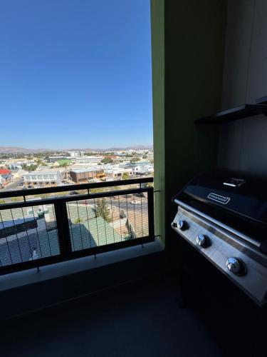 a room with a window with a view of a city at Nami Stay at Merensky in Windhoek