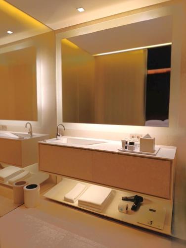 a bathroom with a sink and a large mirror at Hyatt Centric Levent Istanbul in Istanbul