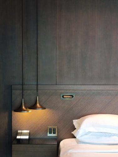 a bedroom with two lights hanging above a bed at Hyatt Centric Levent Istanbul in Istanbul