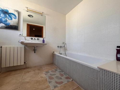 a bathroom with a bath tub and a sink at Villa Montgó in L'Escala
