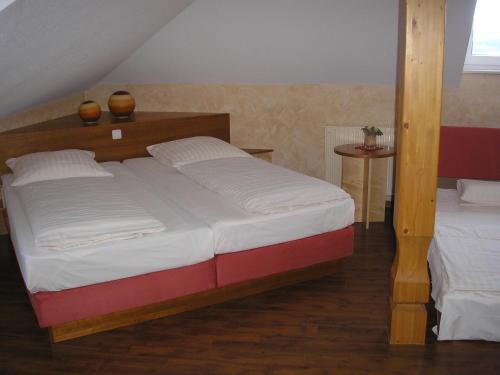 a bedroom with a large bed with white sheets at AKZENT Hotel Altes Casino in Fulda