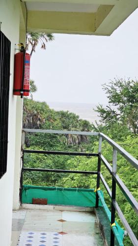 a staircase leading up to a balcony with a view of the ocean at Seafront Homes Stay in Daman