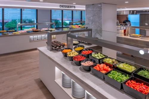 a buffet line with bowls of fruits and vegetables at GHT Oasis Park & Spa in Lloret de Mar