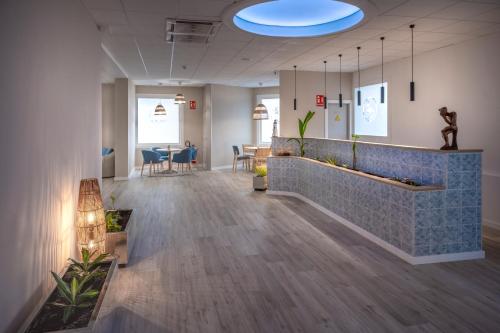 a lobby of an office with a waiting area at GHT Balmes, Hotel-Aparthotel&SPLASH in Calella